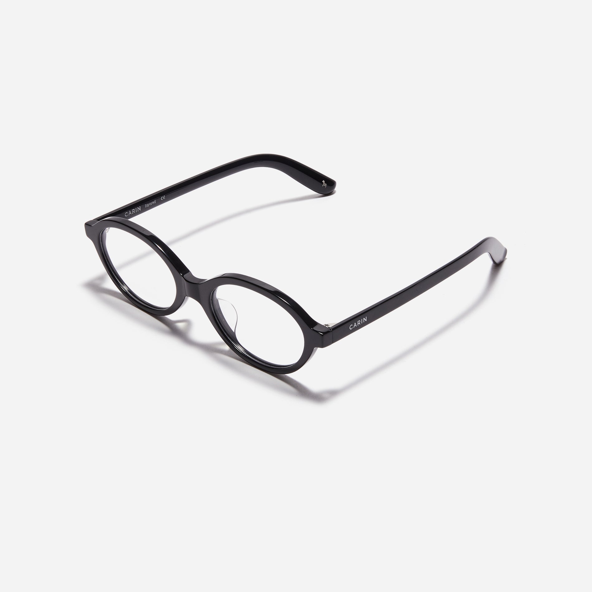 Compact, oval-shaped horn-rimmed eyeglasses featuring a narrow rim and bold frame. Their design captures a modern reinterpretation of 90s retro vibes, providing a trendy and stylish look.