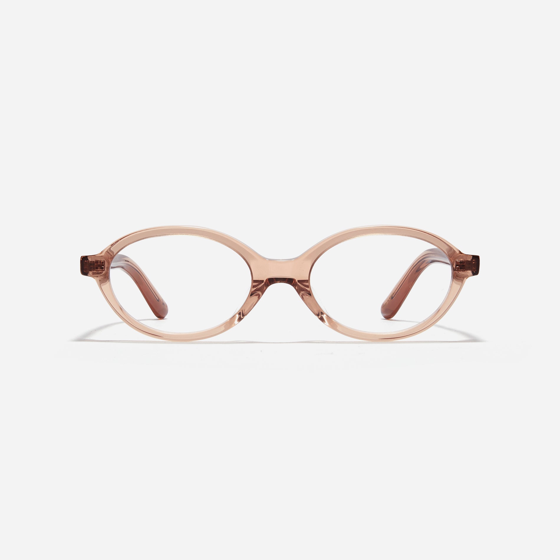 Compact, oval-shaped horn-rimmed eyeglasses featuring a narrow rim and bold frame. Their design captures a modern reinterpretation of 90s retro vibes, providing a trendy and stylish look.