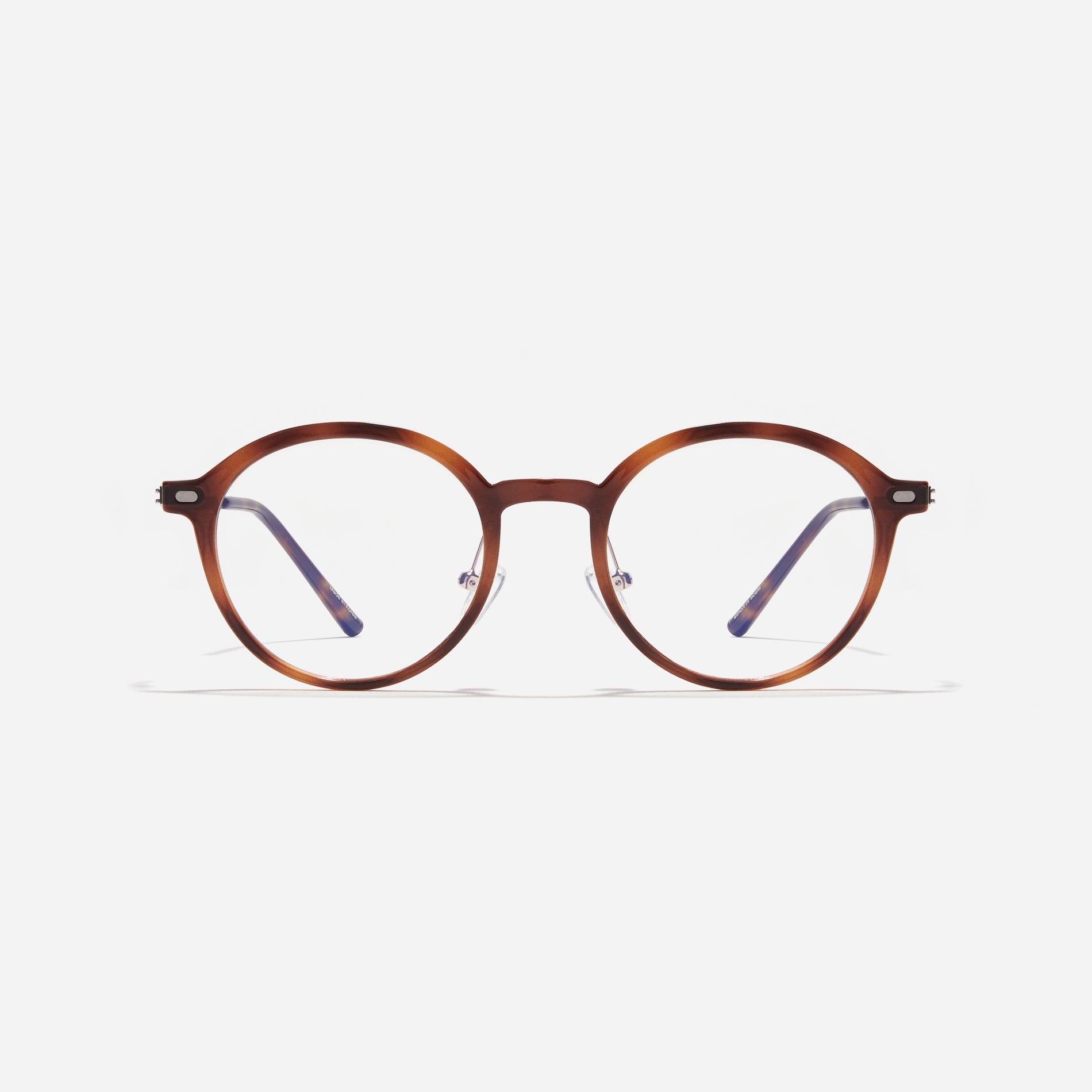 Round-shaped combination eyeglasses from CARIN's 'Feather Fit' line. Their combination frame seamlessly blends bio-plastic and titanium, utilizing advanced injection molding technology, often seen in the manufacturing of cell phones and watches.