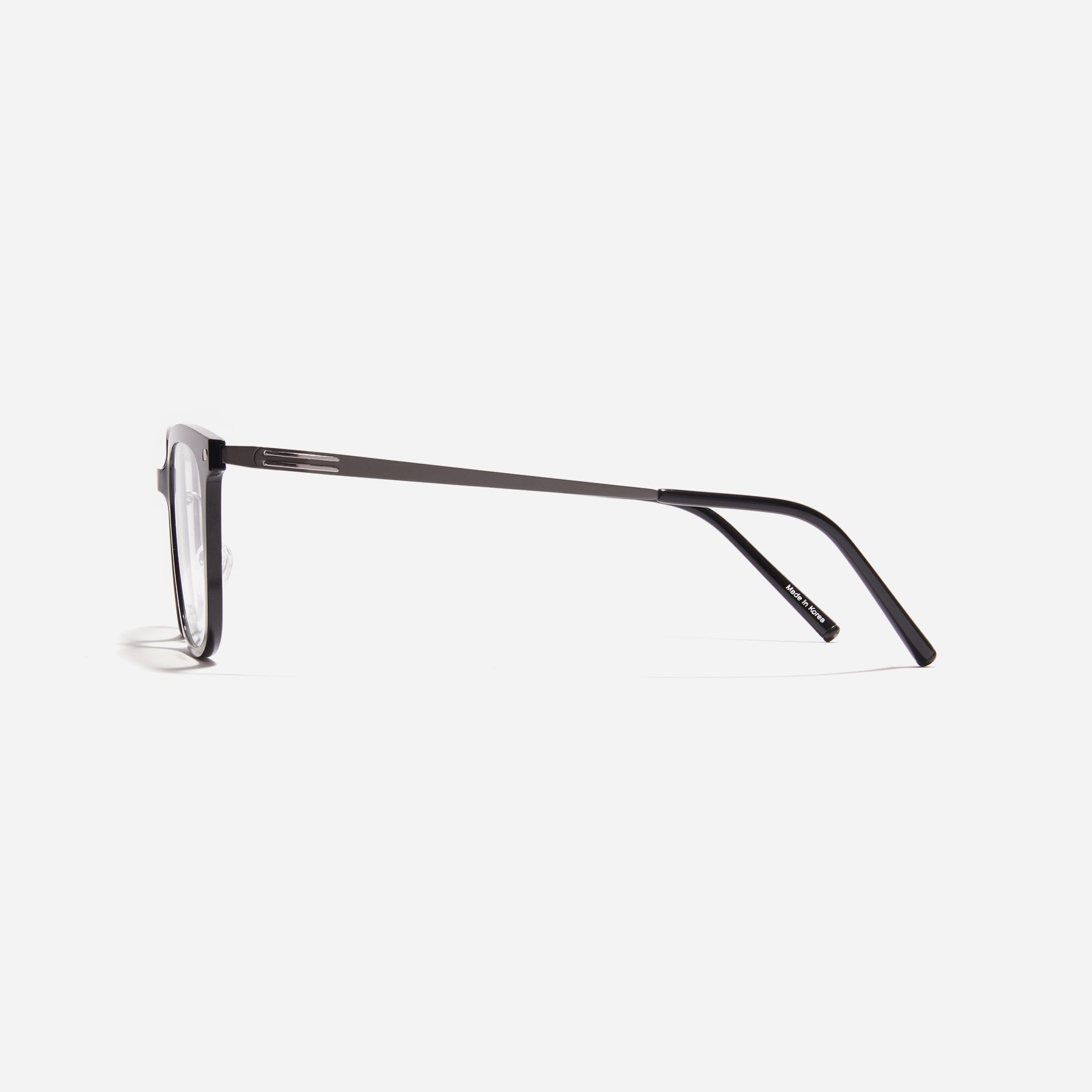 Square-shaped combination eyeglasses from CARIN's 'Feather Fit' line. Their combination frame seamlessly blends bio-plastic and titanium, utilizing advanced injection molding technology, often seen in the manufacturing of cell phones and watches.
