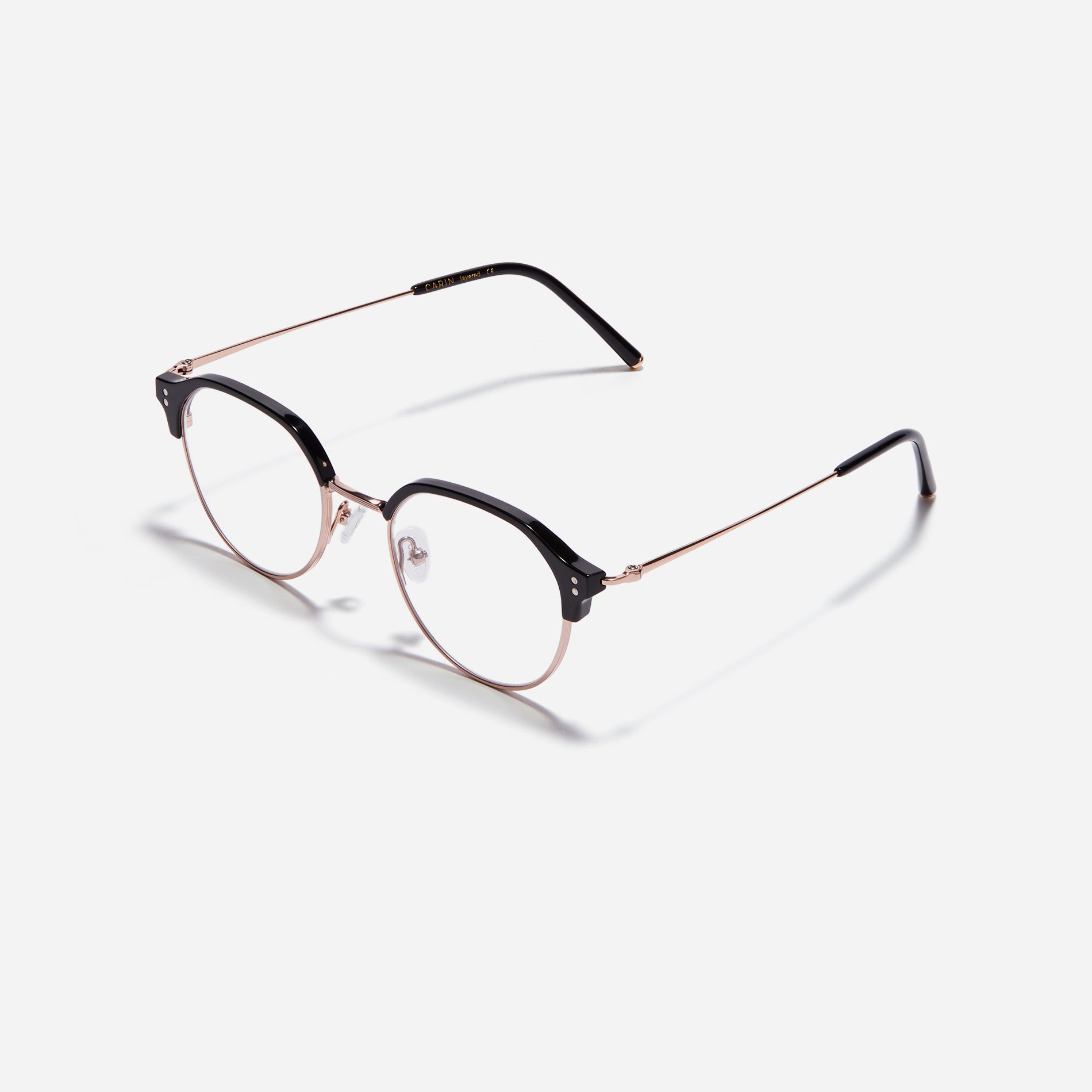 Polygonal-shaped gold-rimmed eyeglasses. The frame, constructed from bioplastic and titanium, seamlessly merges exceptional durability with an ultra-lightweight build, while stylish nose bridge lining details enhance the overall design. The B-titanium temples deliver a lightweight and comfortable fit, guaranteeing prolonged wear without any discomfort.