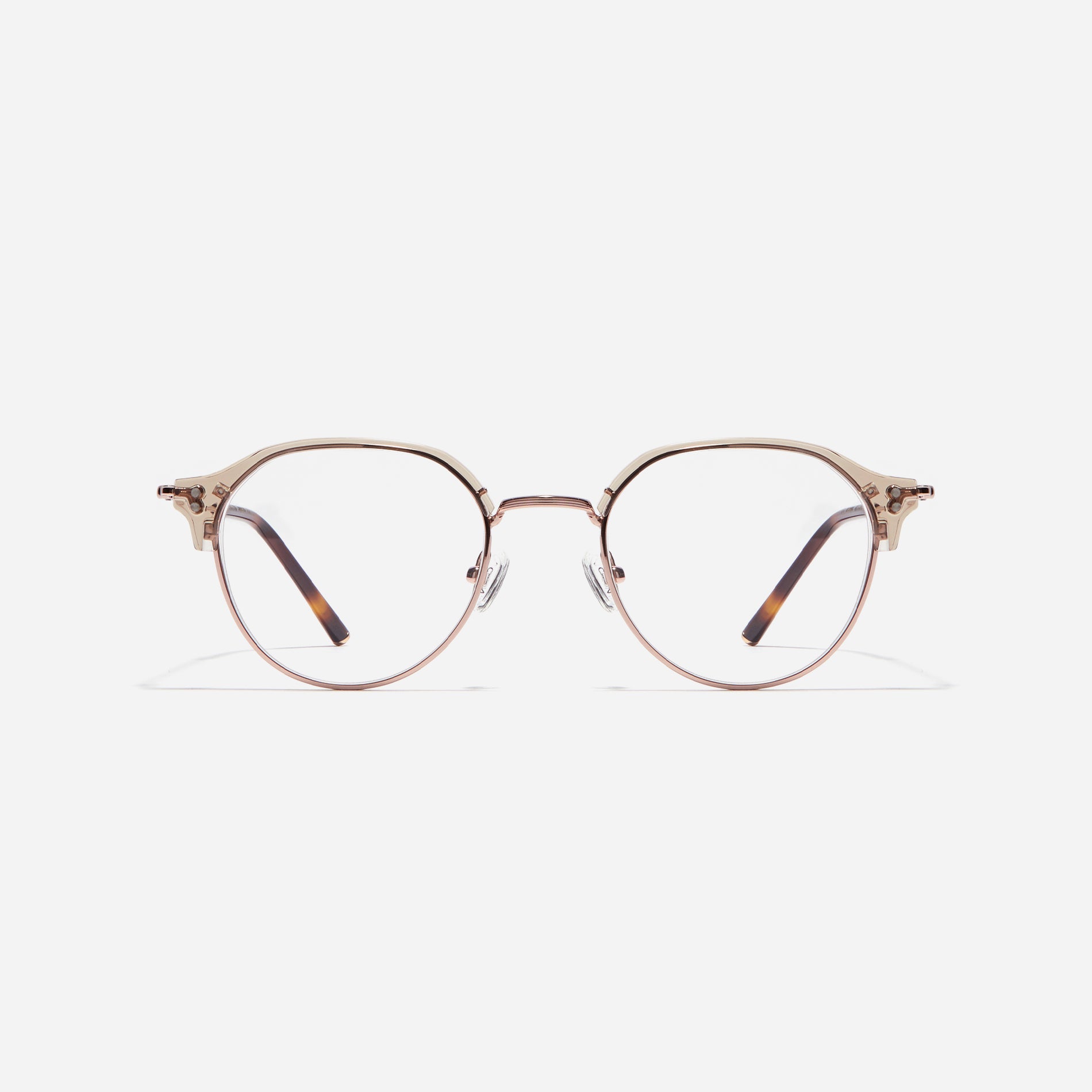 Polygonal-shaped gold-rimmed eyeglasses. The frame, constructed from bioplastic and titanium, seamlessly merges exceptional durability with an ultra-lightweight build, while stylish nose bridge lining details enhance the overall design. The B-titanium temples deliver a lightweight and comfortable fit, guaranteeing prolonged wear without any discomfort.