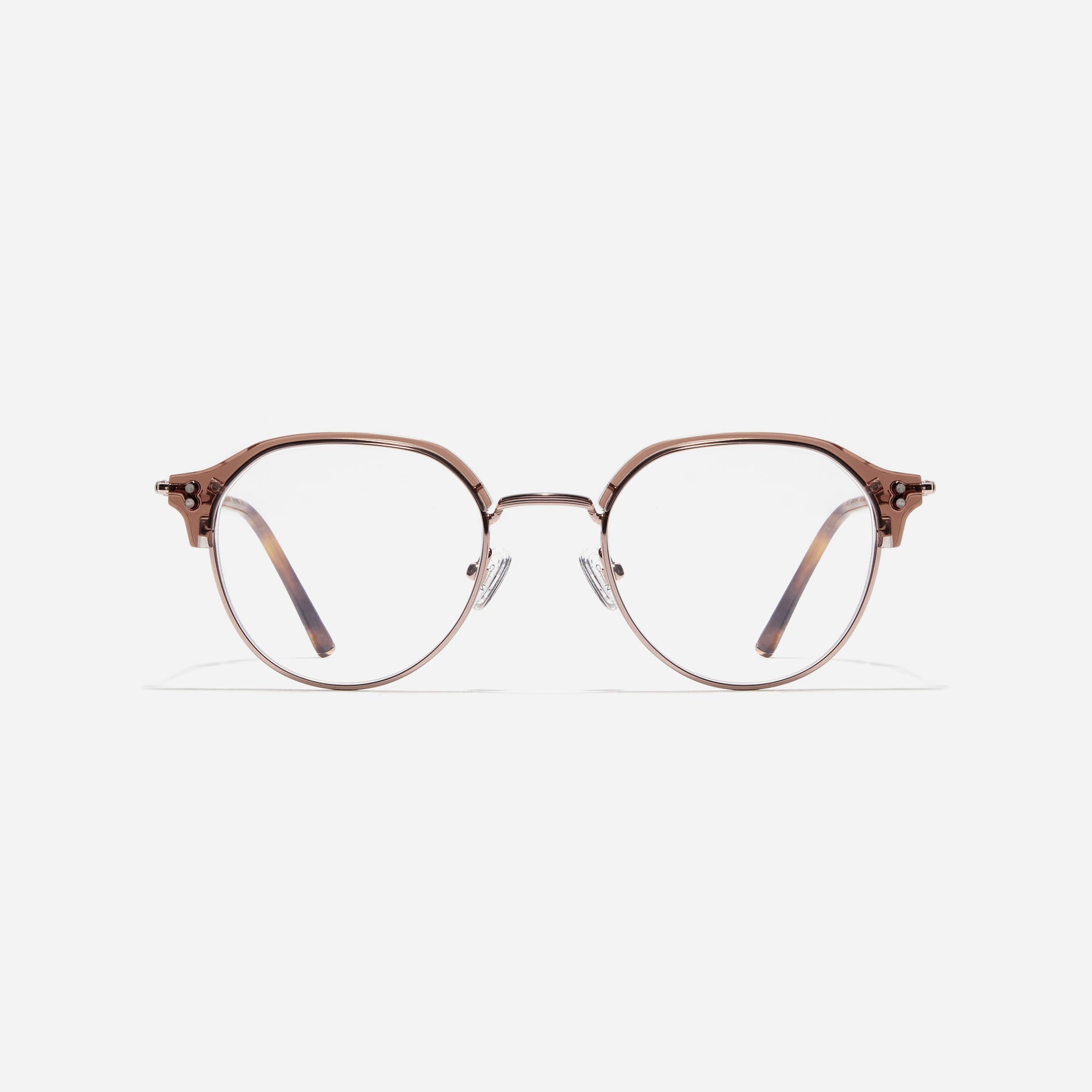 Polygonal-shaped gold-rimmed eyeglasses. The frame, constructed from bioplastic and titanium, seamlessly merges exceptional durability with an ultra-lightweight build, while stylish nose bridge lining details enhance the overall design. The B-titanium temples deliver a lightweight and comfortable fit, guaranteeing prolonged wear without any discomfort.