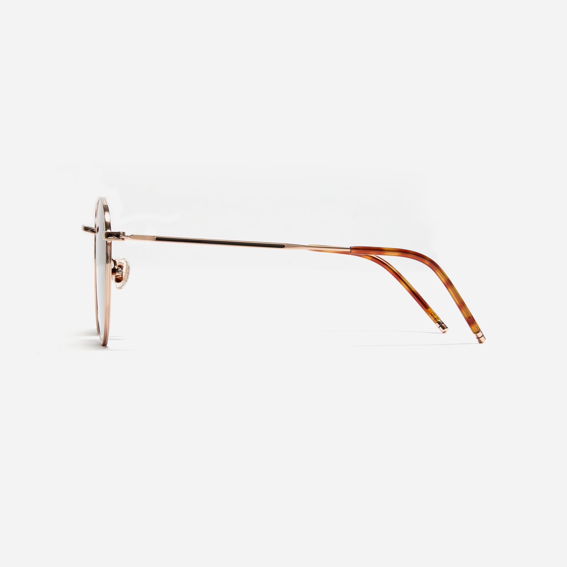 Round-shaped metal sunglasses that offer a soft and natural look with a peach-shaded titanium frame.