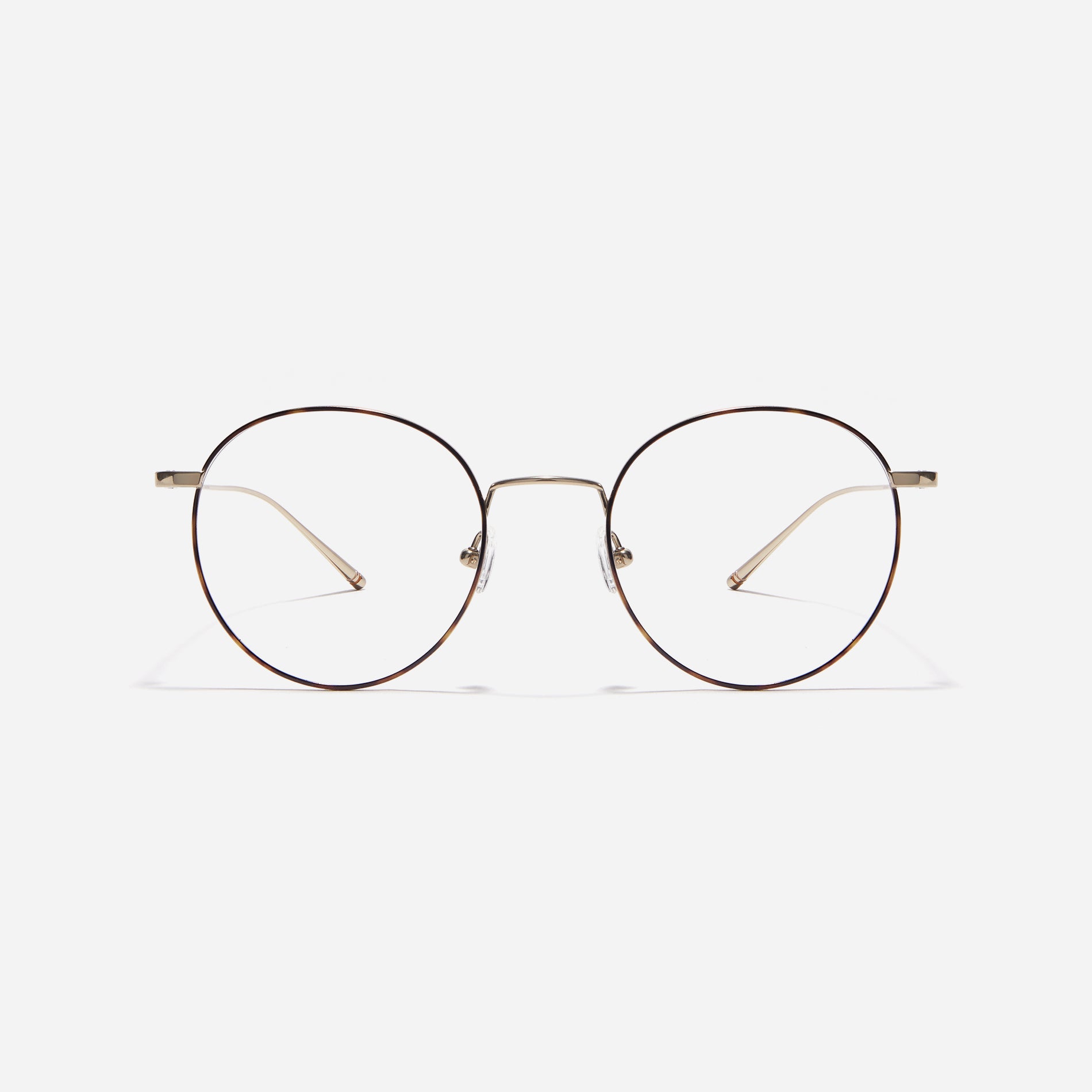 Round-shaped eyeglasses that naturally complement all face shapes. Crafted entirely from titanium, the frame provides exceptional durability and featherweight comfort, while its design adds a touch of casual charm to one's daily style.