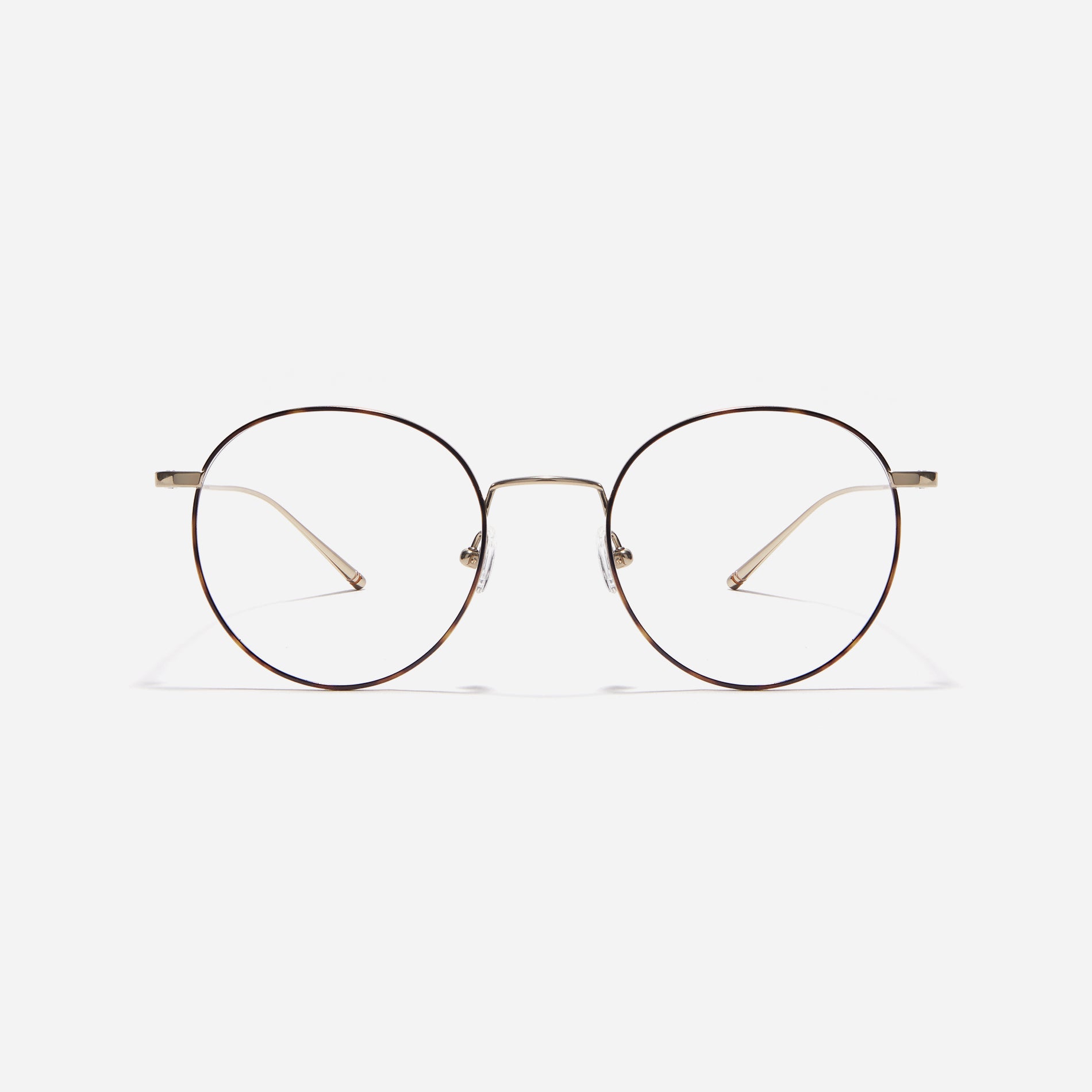 Round-shaped eyeglasses that naturally complement all face shapes. Crafted entirely from titanium, the frame provides exceptional durability and featherweight comfort, while its design adds a touch of casual charm to one's daily style.