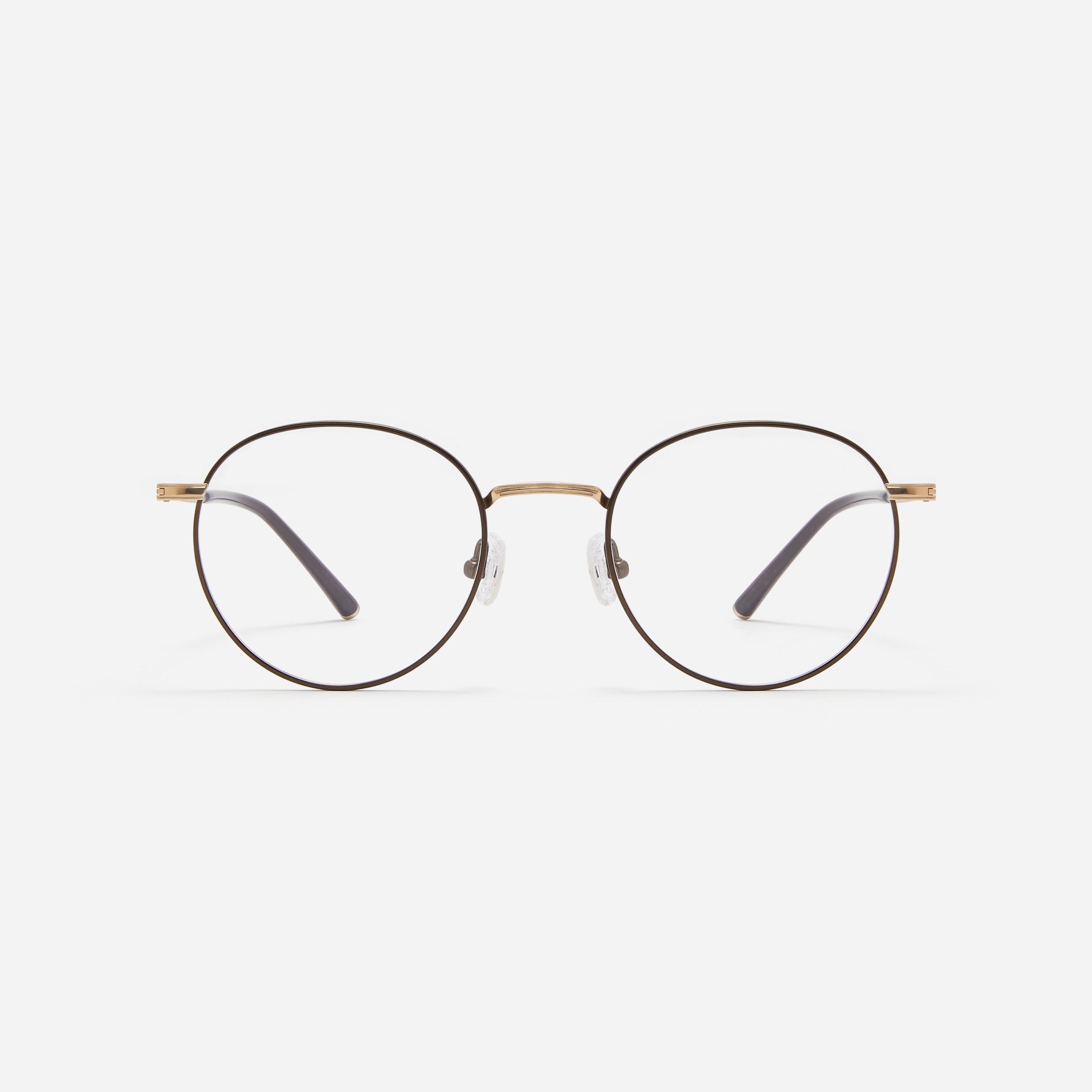 Round-shaped blue light blocking eyeglasses. Crafted entirely from pure titanium, they offer a lightweight and comfortable wearing experience. The three-dimensional lining details on the frame and temples, combined with epoxy and matte plating, enhance its classic ambiance.