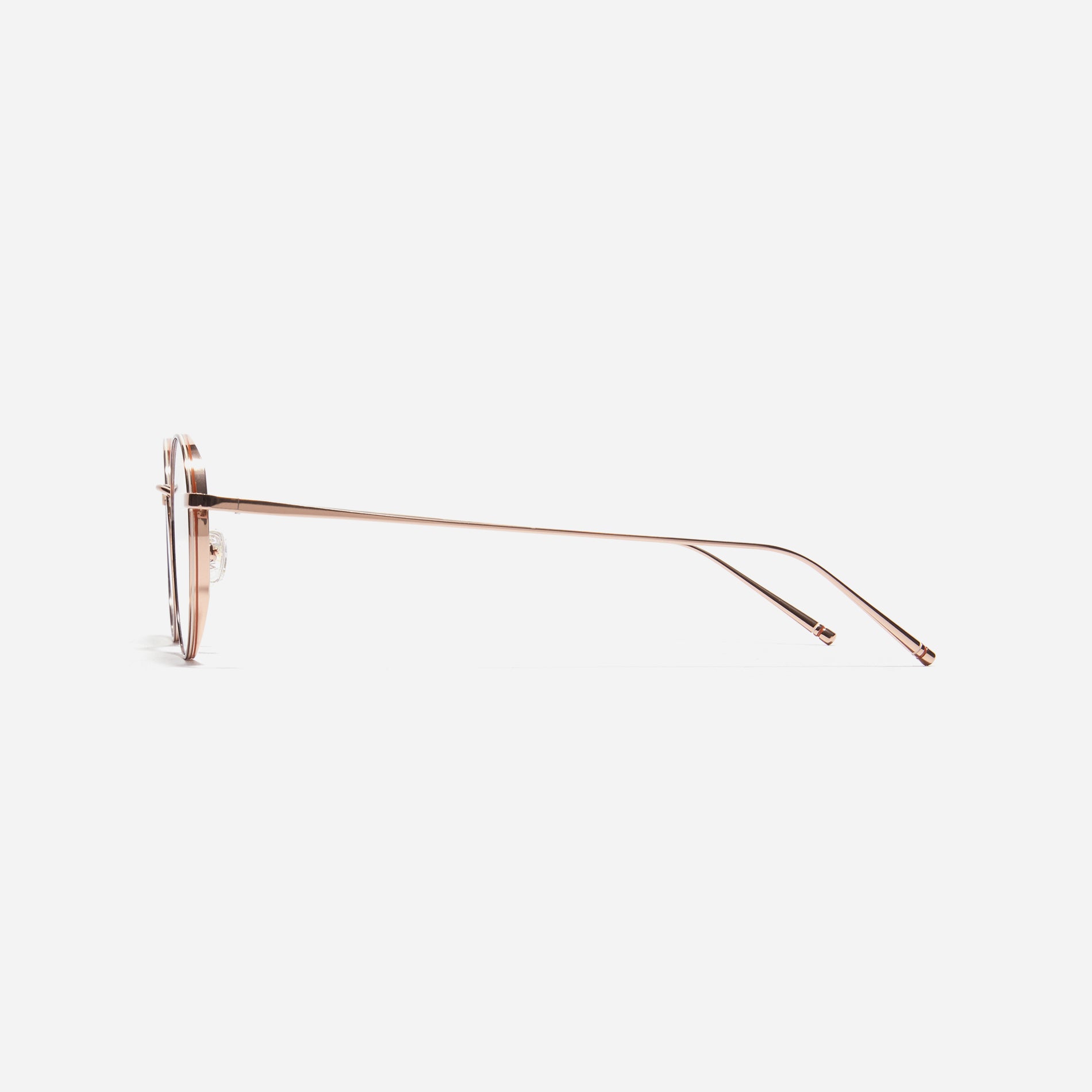 Round-shaped titanium eyeglasses inspired by the aesthetics of platform shoes. Their dual-rim structure effortlessly accommodates the use of thick lenses for higher prescriptions, while retro vibes shine through side color accents applied using epoxy techniques.