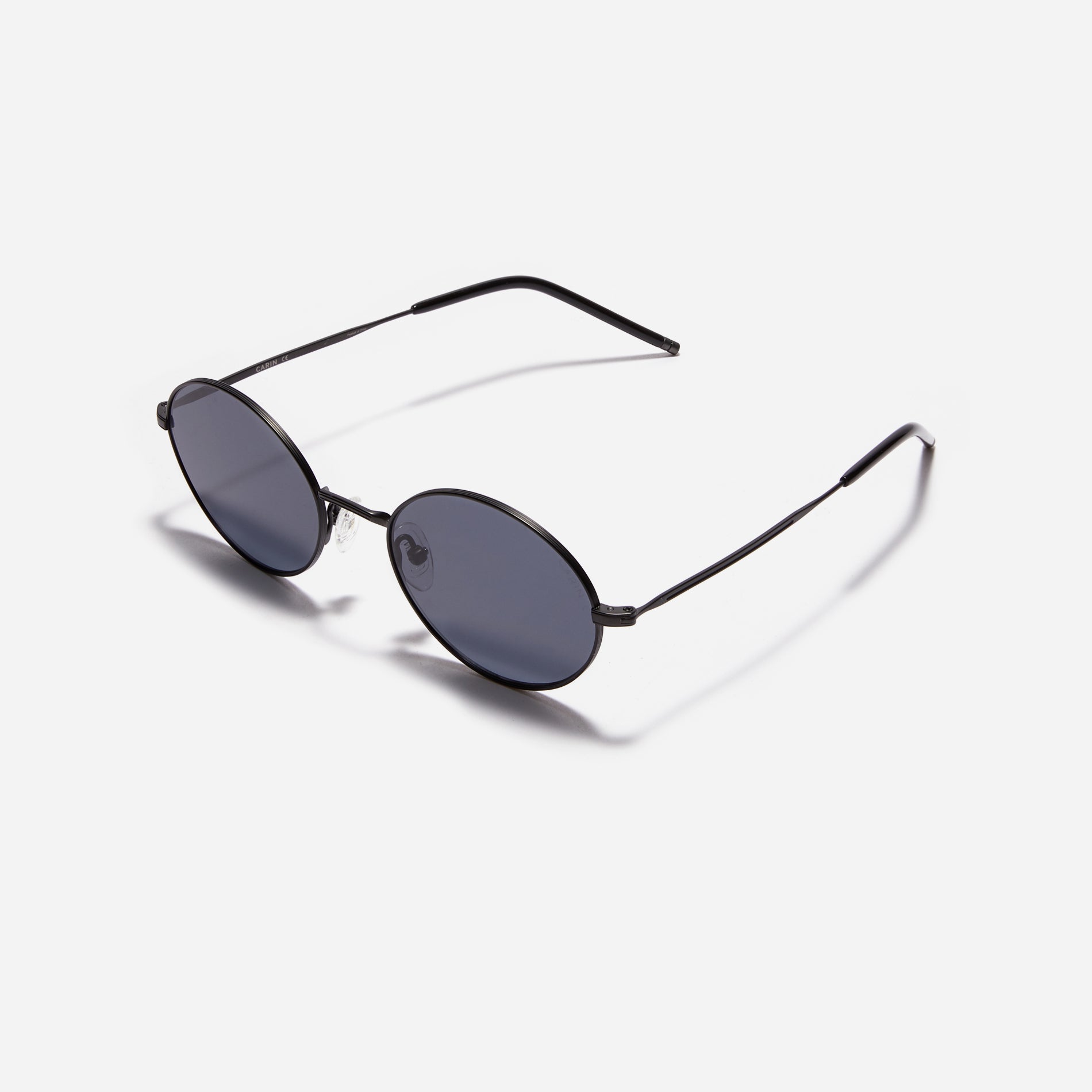 Tinted sunglasses with an oval frame crafted entirely from titanium.