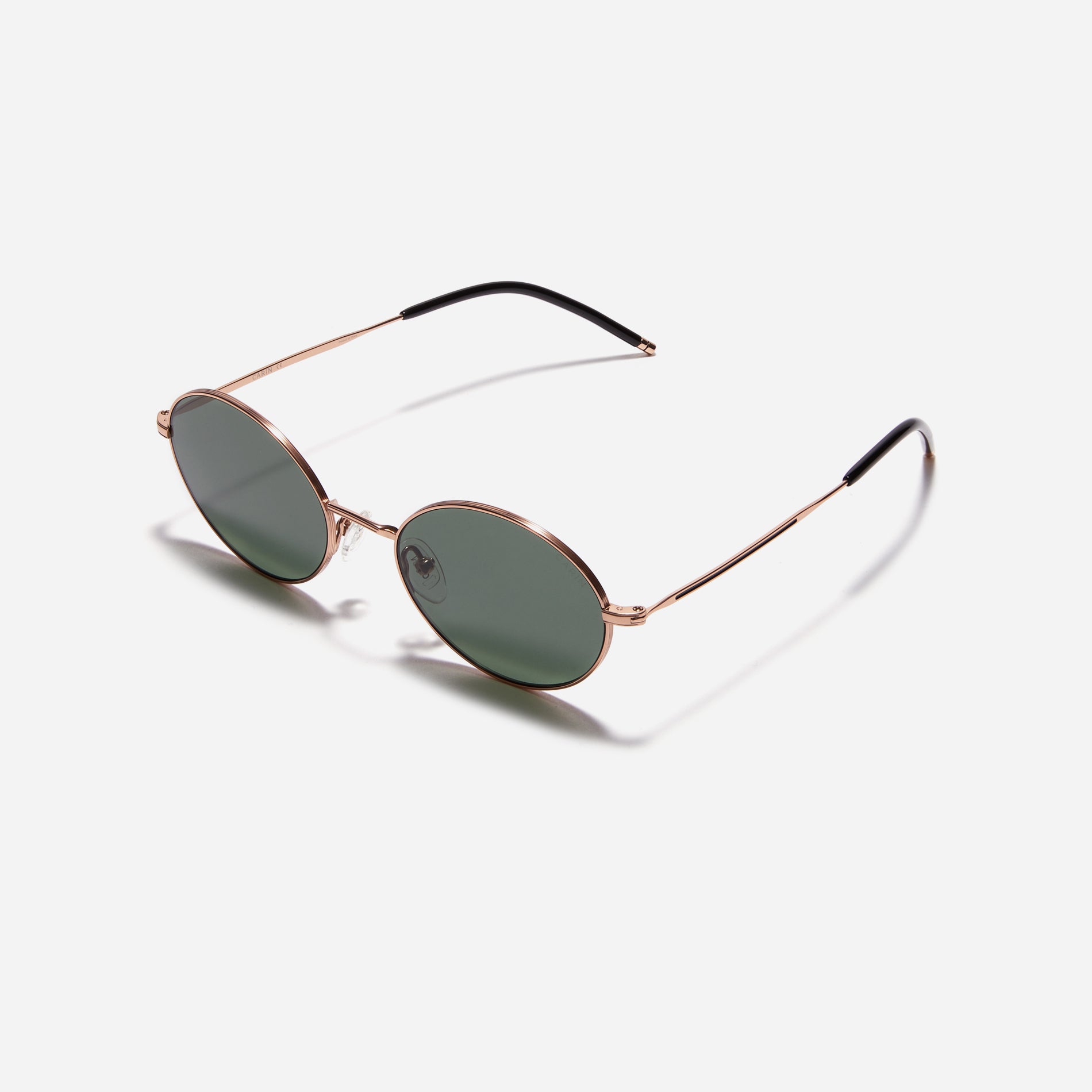 Tinted sunglasses with an oval frame crafted entirely from titanium.