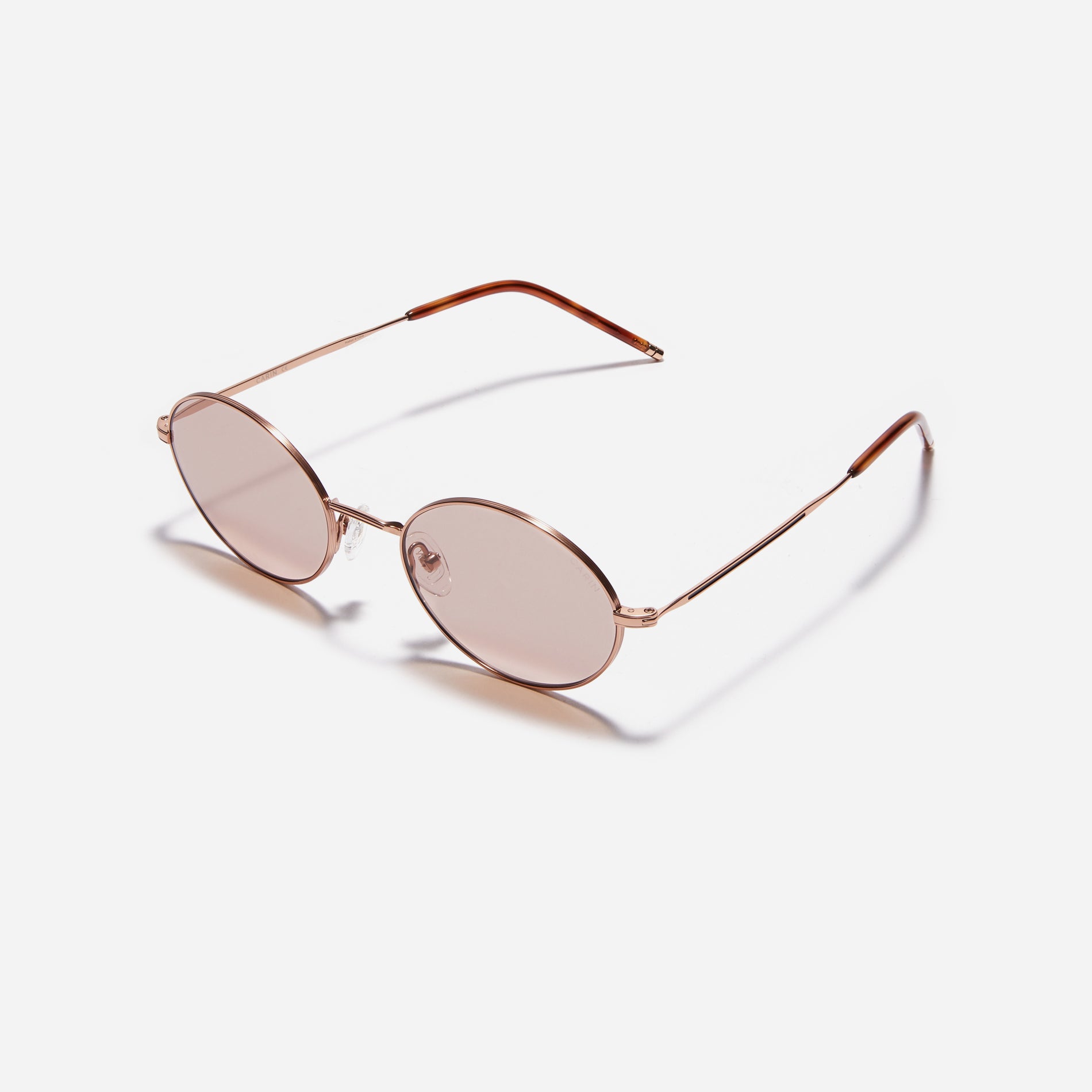 Tinted sunglasses with an oval frame crafted entirely from titanium.