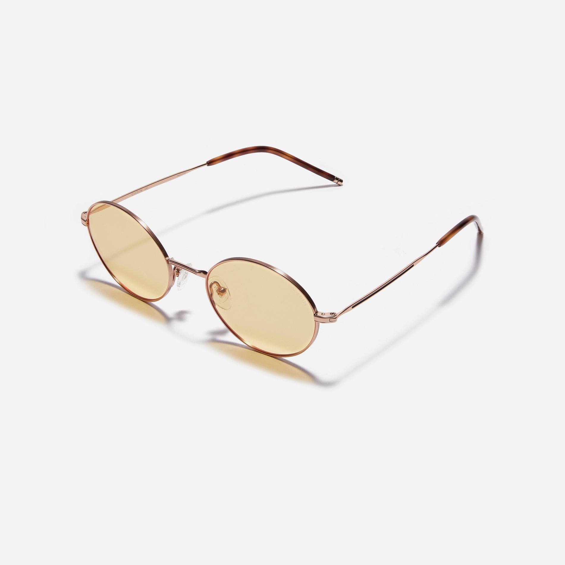 Tinted sunglasses with an oval frame crafted entirely from titanium.