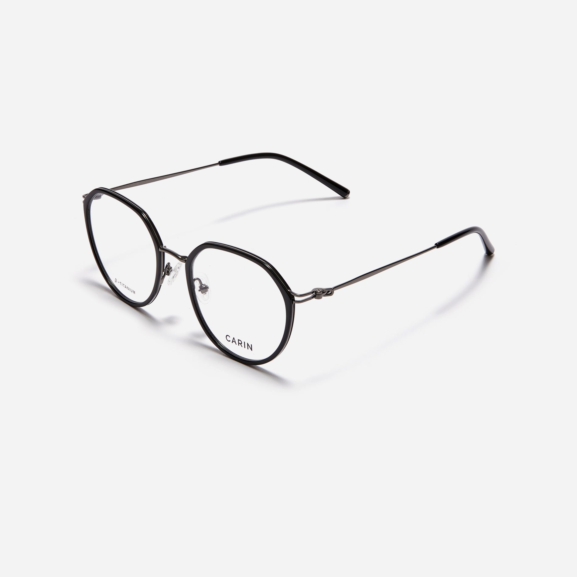 Combination eyeglasses featuring a harmonious blend of a polygonal lens shape and an acetate frame. These eyeglasses are characterized by a delicate acetate rim that secures the frame and hinge details. The slim temples, made from lightweight and elastic B-Titanium material, ensure a consistently comfortable fit.