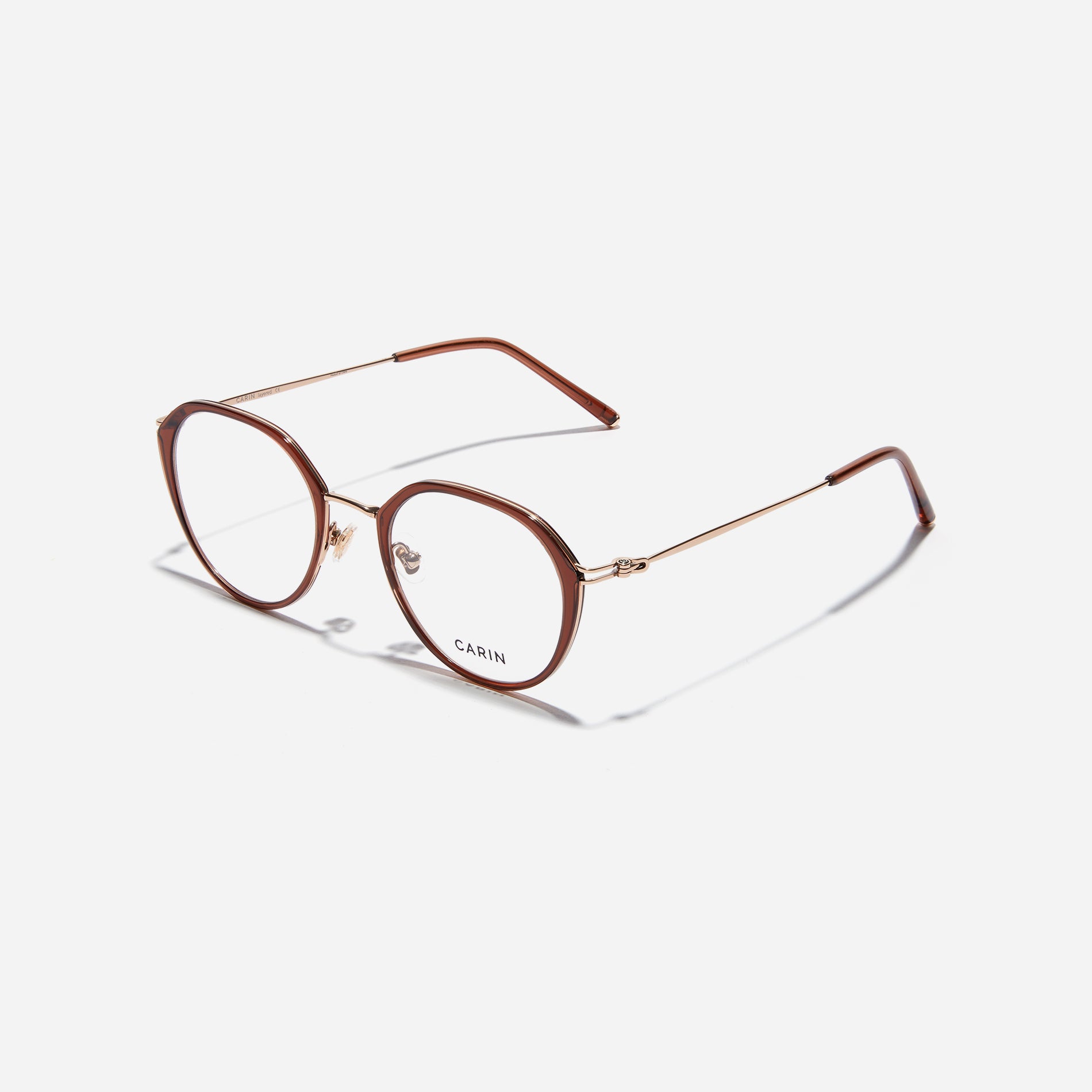Polygonal-shaped eyeglasses that feature a contrasting round lens design, offering a smooth yet refined style. They provide a comfortable wearing experience with slim temples made from lightweight and elastic B-Titanium material.
