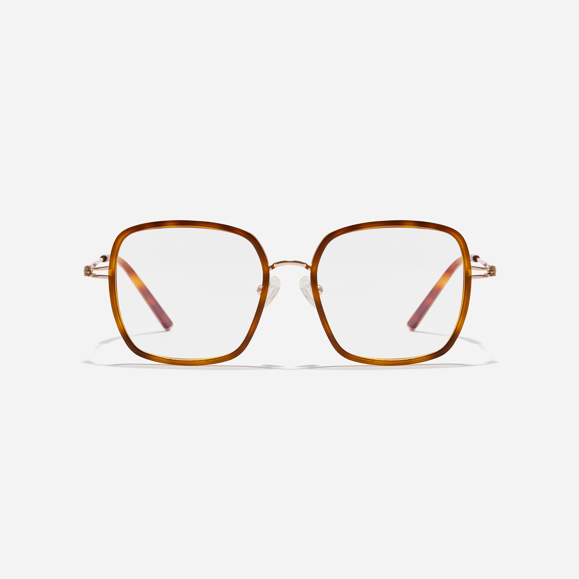 Rectangular-shaped oversized eyeglasses characterized by a delicate acetate rim that secures the frame and hinge details. The slim temples, made from lightweight and elastic B-Titanium material, ensure a consistently comfortable fit.