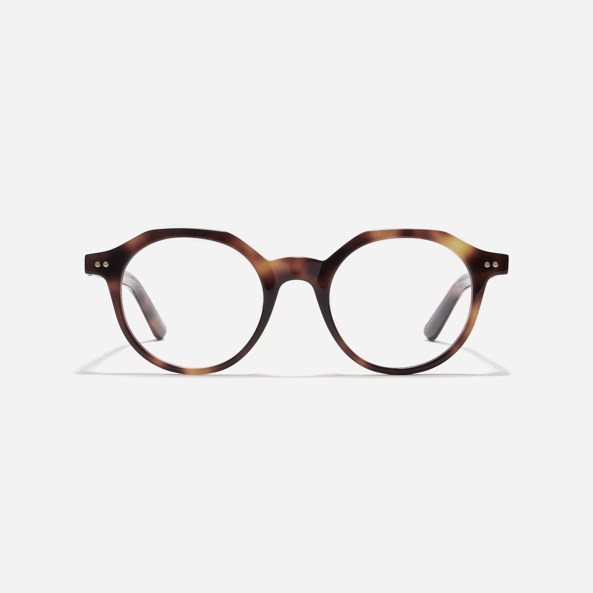 Polygon-shaped horn-rimmed eyeglasses. Embodying a modern reinterpretation of '90s retro vibes, their design is created for effortless styling. Featuring a distinctive bold frame and a stylish polygonal shape, these eyeglasses are available in a variety of colors.