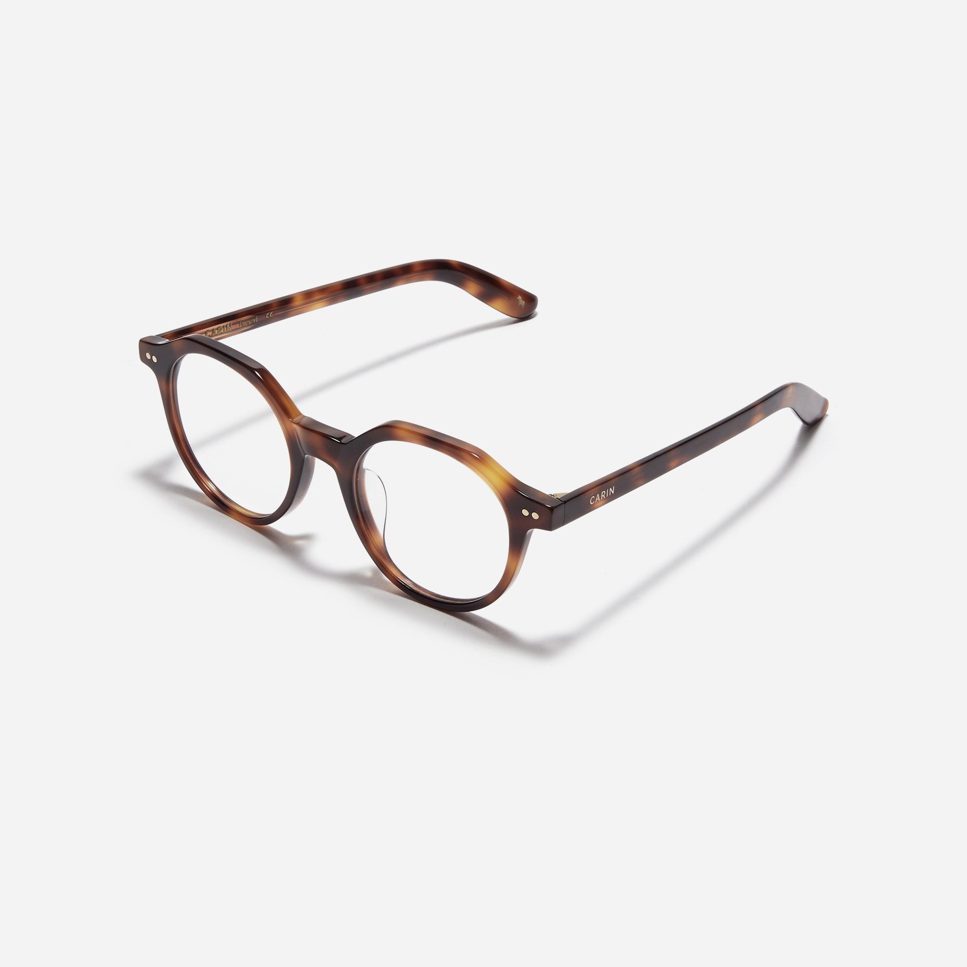 Polygon-shaped horn-rimmed eyeglasses. Embodying a modern reinterpretation of '90s retro vibes, their design is created for effortless styling. Featuring a distinctive bold frame and a stylish polygonal shape, these eyeglasses are available in a variety of colors.