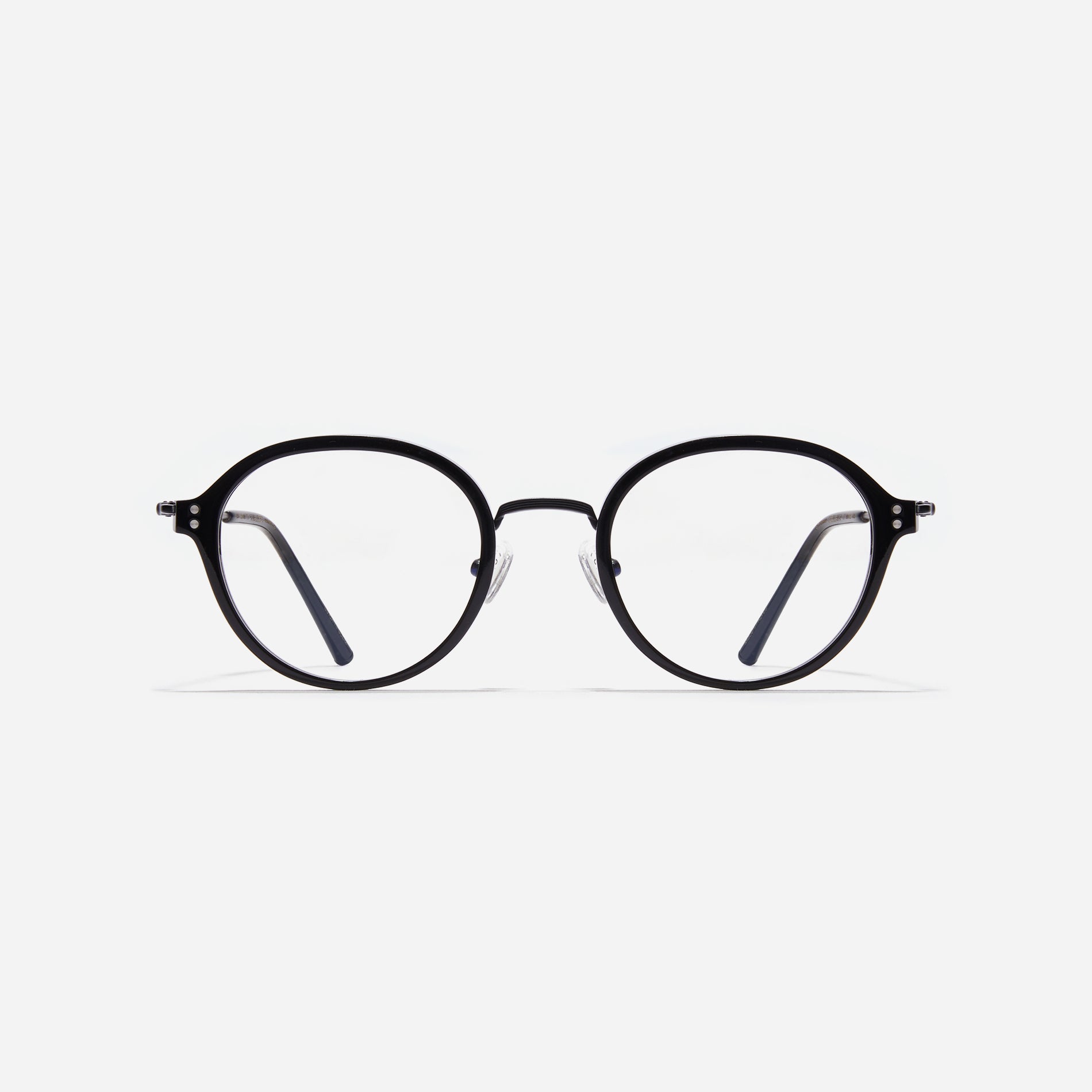 Round-shaped eyeglasses with a dual-combi structure inspired by from the aesthetics of platform shoes. Their dual-rim structure seamlessly accommodates thick lenses for higher prescriptions, while retro vibes are accentuated by side color accents.