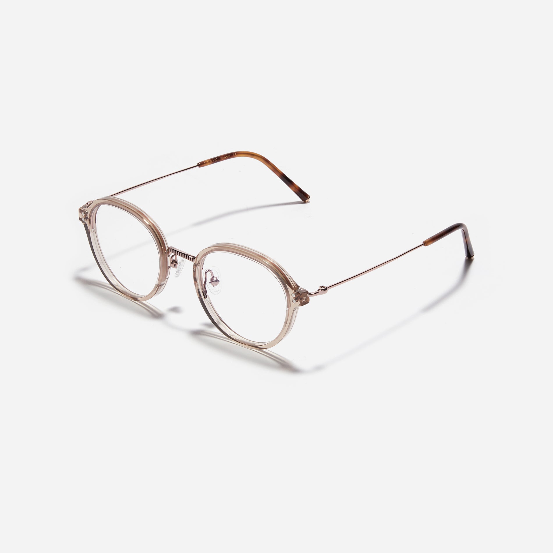 Round-shaped eyeglasses with a dual-combi structure inspired by from the aesthetics of platform shoes. Their dual-rim structure seamlessly accommodates thick lenses for higher prescriptions, while retro vibes are accentuated by side color accents.