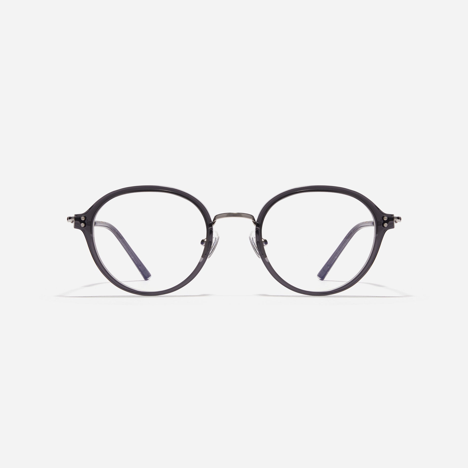 Round-shaped eyeglasses with a dual-combi structure inspired by from the aesthetics of platform shoes. Their dual-rim structure seamlessly accommodates thick lenses for higher prescriptions, while retro vibes are accentuated by side color accents.