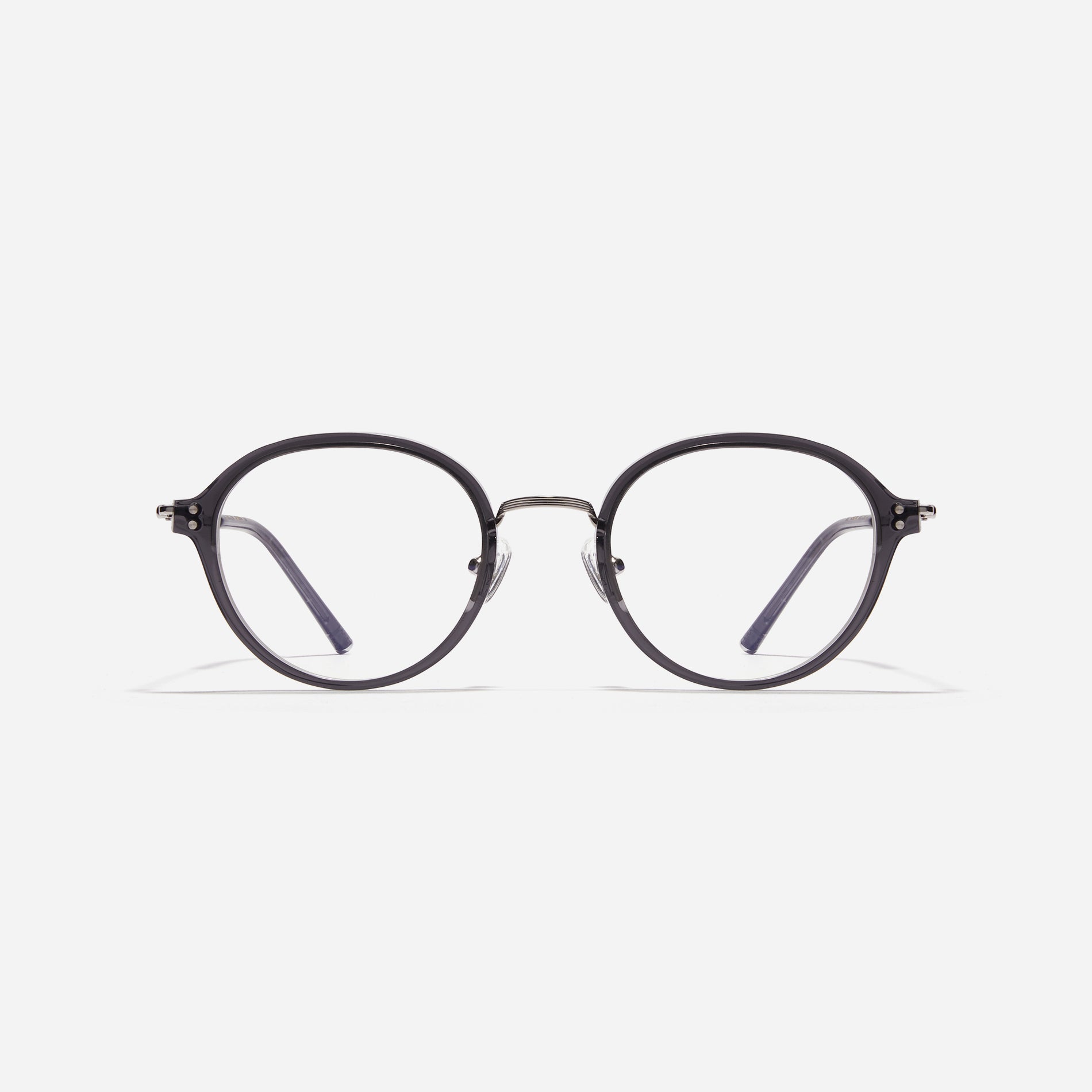 Round-shaped eyeglasses with a dual-combi structure inspired by from the aesthetics of platform shoes. Their dual-rim structure seamlessly accommodates thick lenses for higher prescriptions, while retro vibes are accentuated by side color accents.