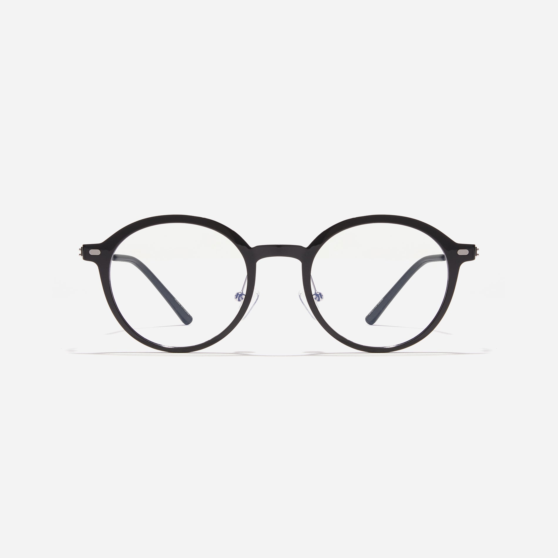 Round-shaped combination eyeglasses from CARIN's 'Feather Fit' line. Their combination frame seamlessly blends bio-plastic and titanium, utilizing advanced injection molding technology, often seen in the manufacturing of cell phones and watches.