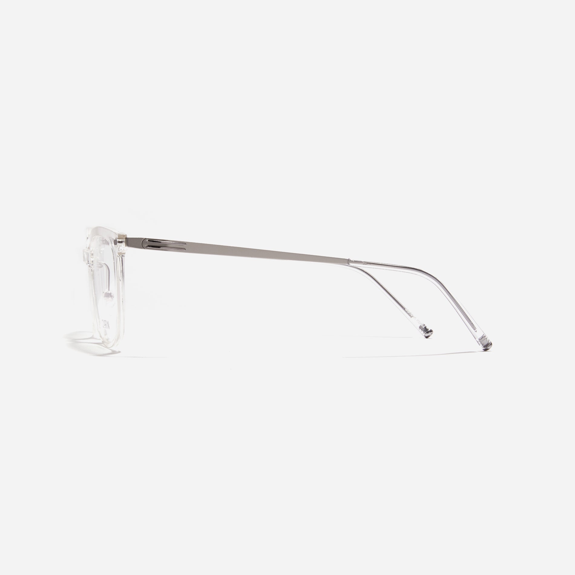 Square-shaped combination eyeglasses from CARIN's 'Feather Fit' line. Their combination frame seamlessly blends bio-plastic and titanium, utilizing advanced injection molding technology, often seen in the manufacturing of cell phones and watches. 