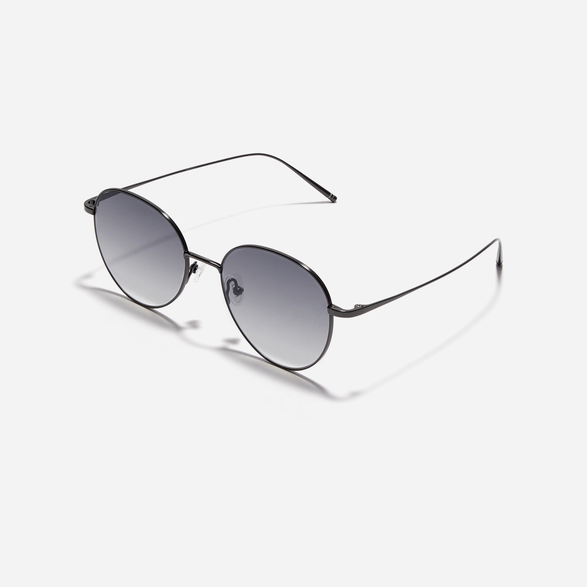 Round-shaped sunglasses crafted entirely from lightweight titanium. They feature semi-mirrored lenses that effectively reflect light, minimizing eye fatigue.