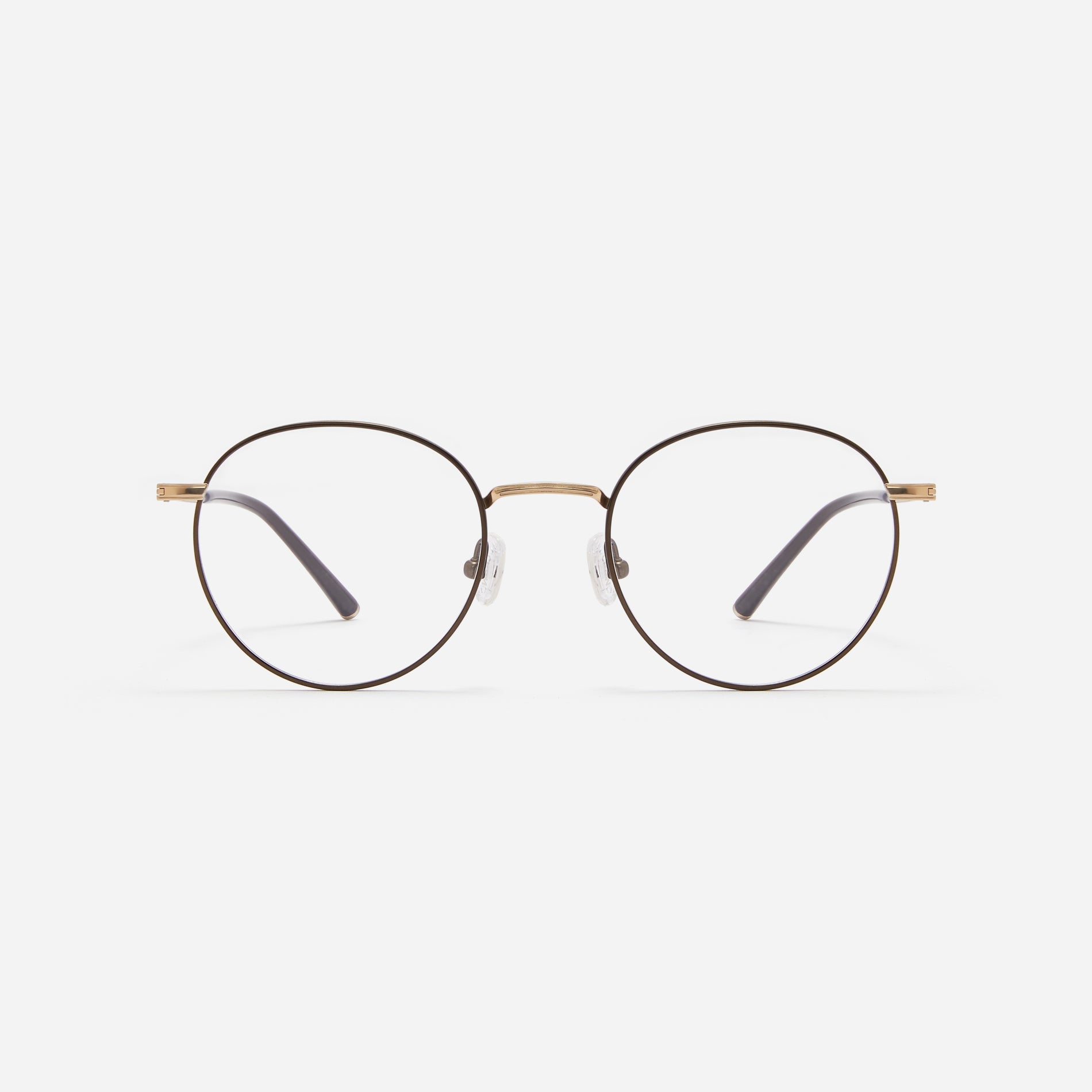 Round-shaped blue light blocking eyeglasses. Crafted entirely from pure titanium, they offer a lightweight and comfortable wearing experience.  The three-dimensional lining details on the frame and temples, combined with epoxy and matte plating, enhance its classic ambiance. 