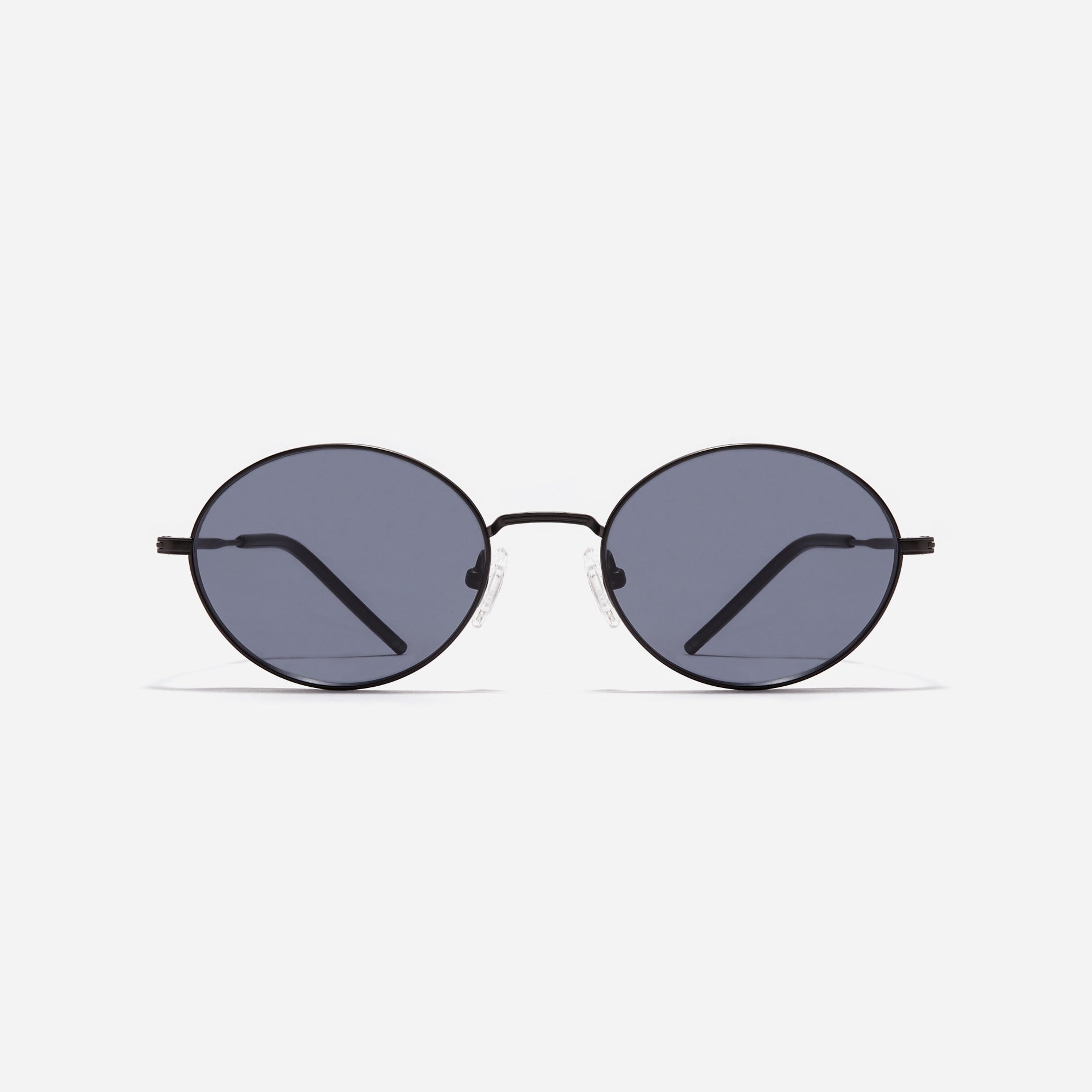 Tinted sunglasses with an oval frame crafted entirely from titanium.