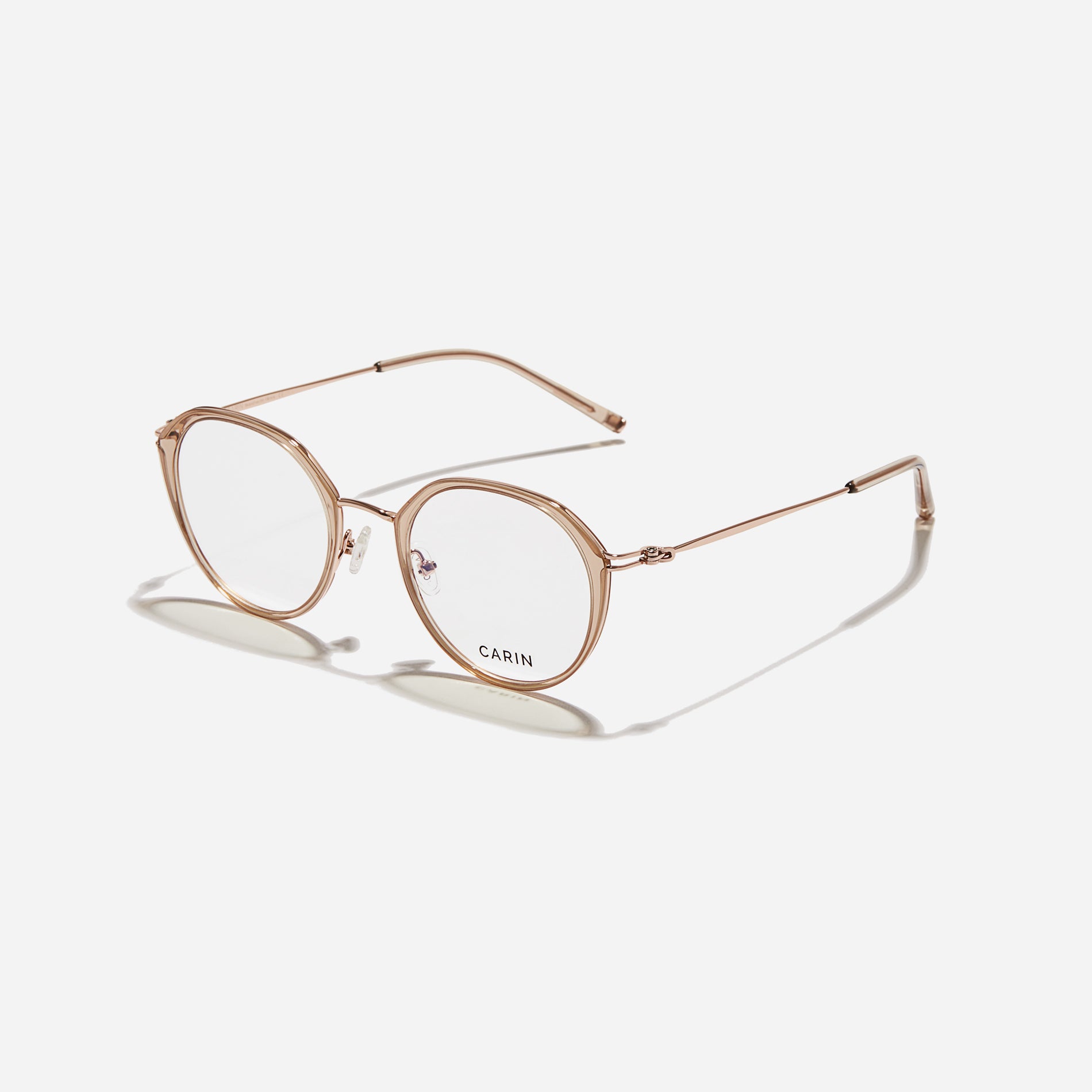 Polygonal-shaped eyeglasses that feature a contrasting round lens design, offering a smooth yet refined style.  They provide a comfortable wearing experience with slim temples made from lightweight and elastic B-Titanium material.