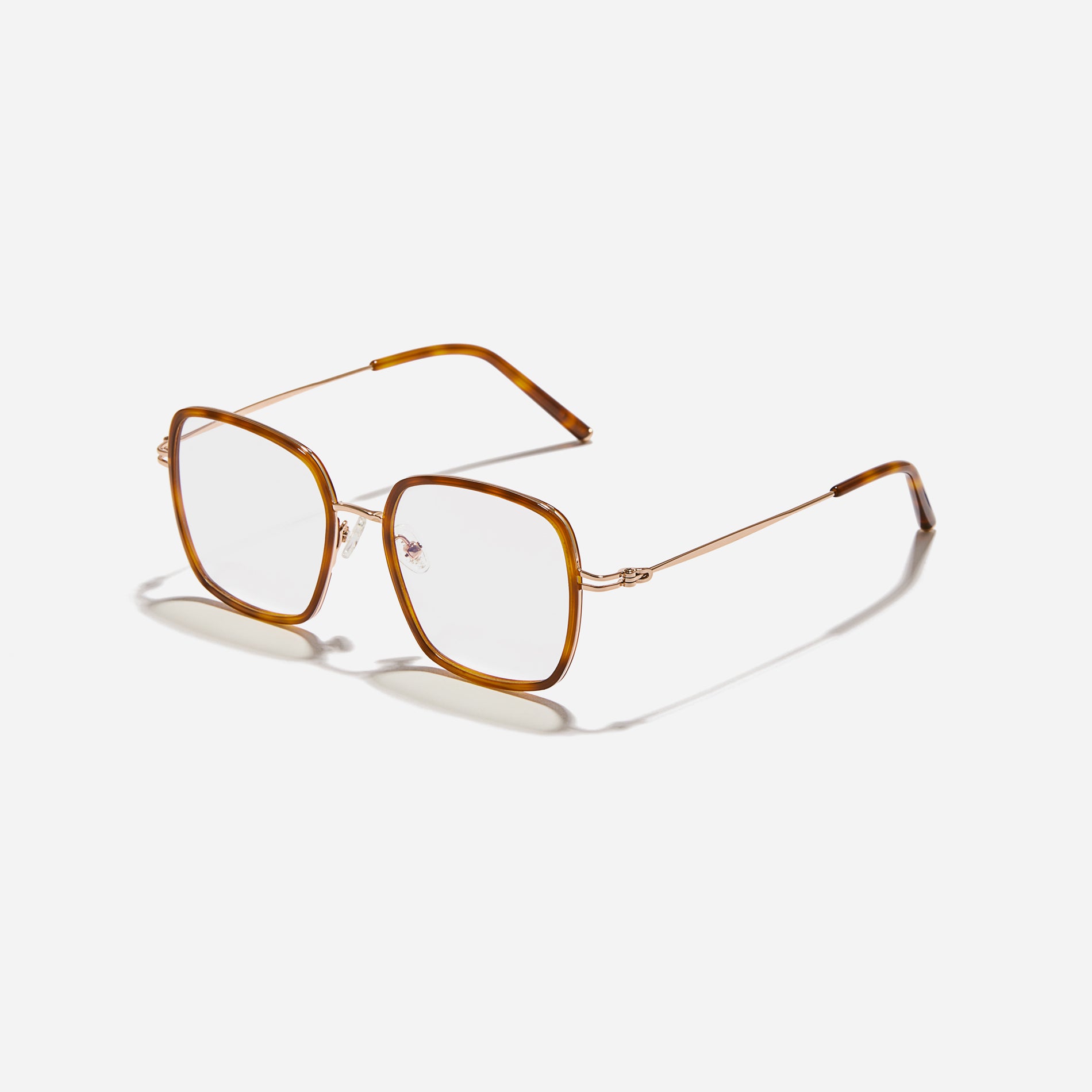Rectangular-shaped oversized eyeglasses  characterized by a delicate acetate rim that secures the frame and hinge details.  The slim temples, made from lightweight and elastic B-Titanium material, ensure a consistently comfortable fit.