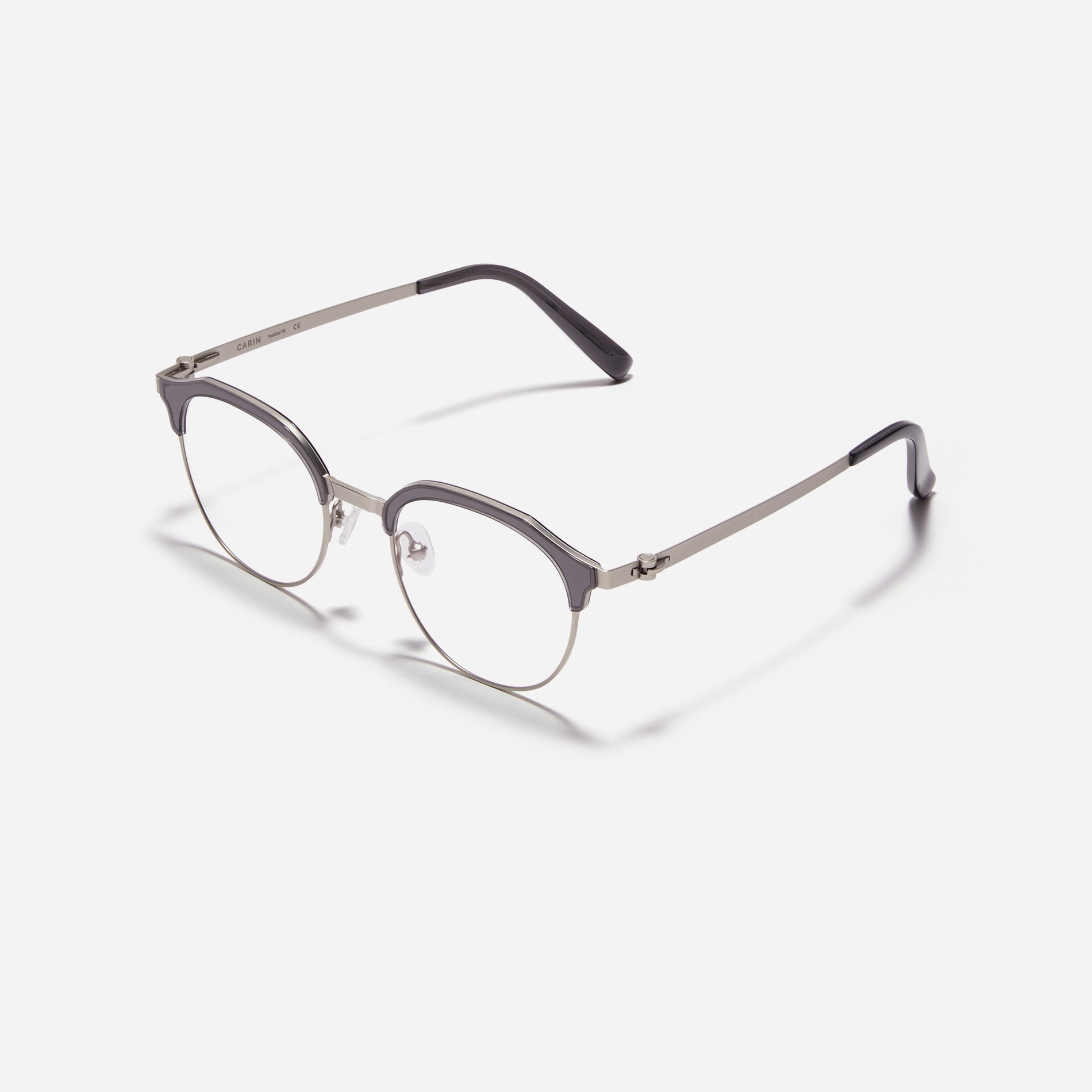 Lightweight polygon-shaped eyeglasses from CARIN's 'Feather Fit' line, offering a contemporary twist on the classic browline design. 