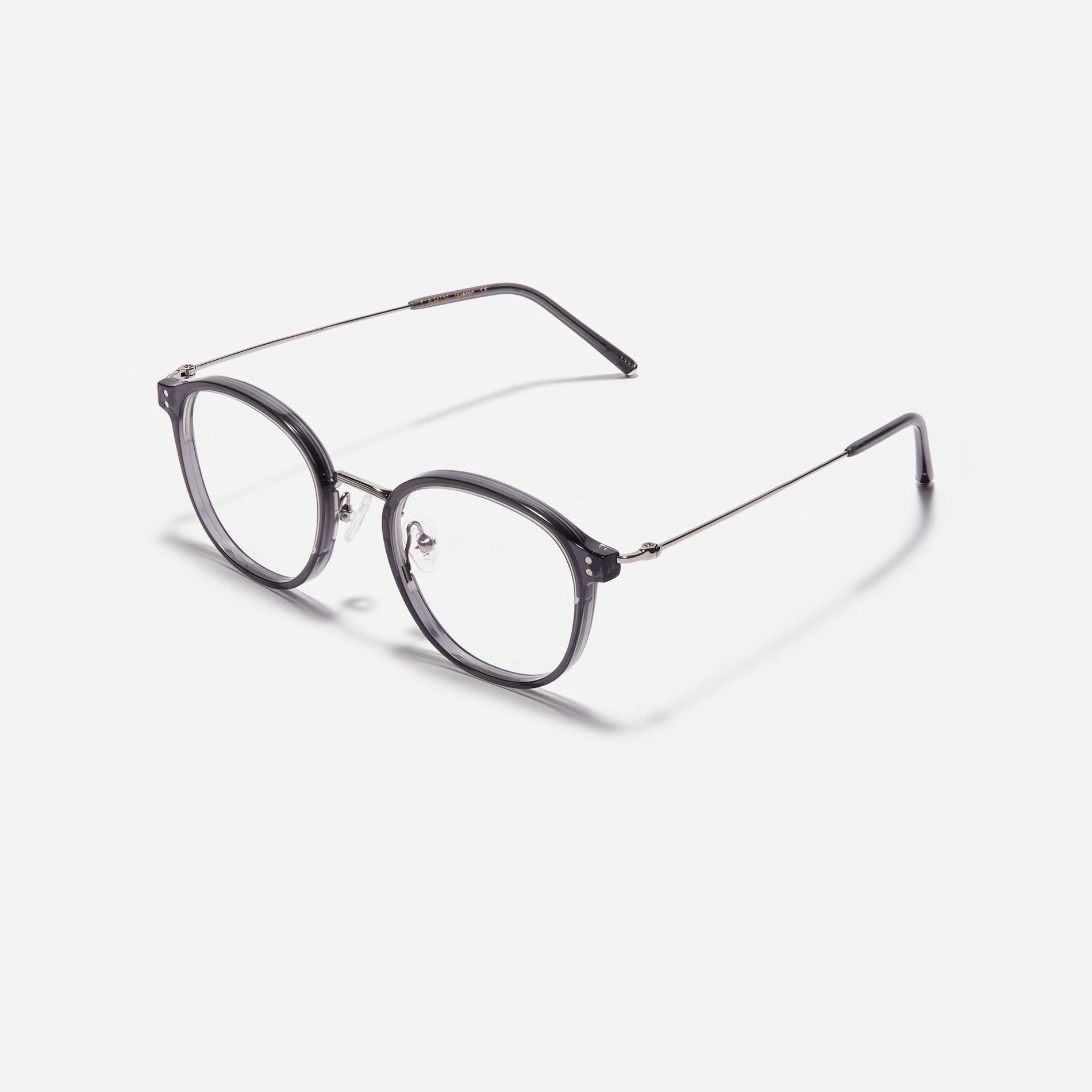Square-shaped eyeglasses with a dual-combi structure inspired by from the aesthetics of platform shoes. Their dual-rim structure seamlessly accommodates thick lenses for higher prescriptions, while retro vibes are accentuated by side color accents applied using epoxy techniques.